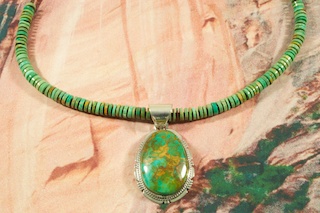 Genuine Crow Springs Turquoise set in Sterling Silver Pendant on a Crow Springs Turquoise Necklace. The Crow Springs Necklace features Penshell Heishi with Sterling Silver Clasp. Created by Navajo Artist Phillip Sanchez. The Crow Springs Mine is located near Tonopah, Nevada.